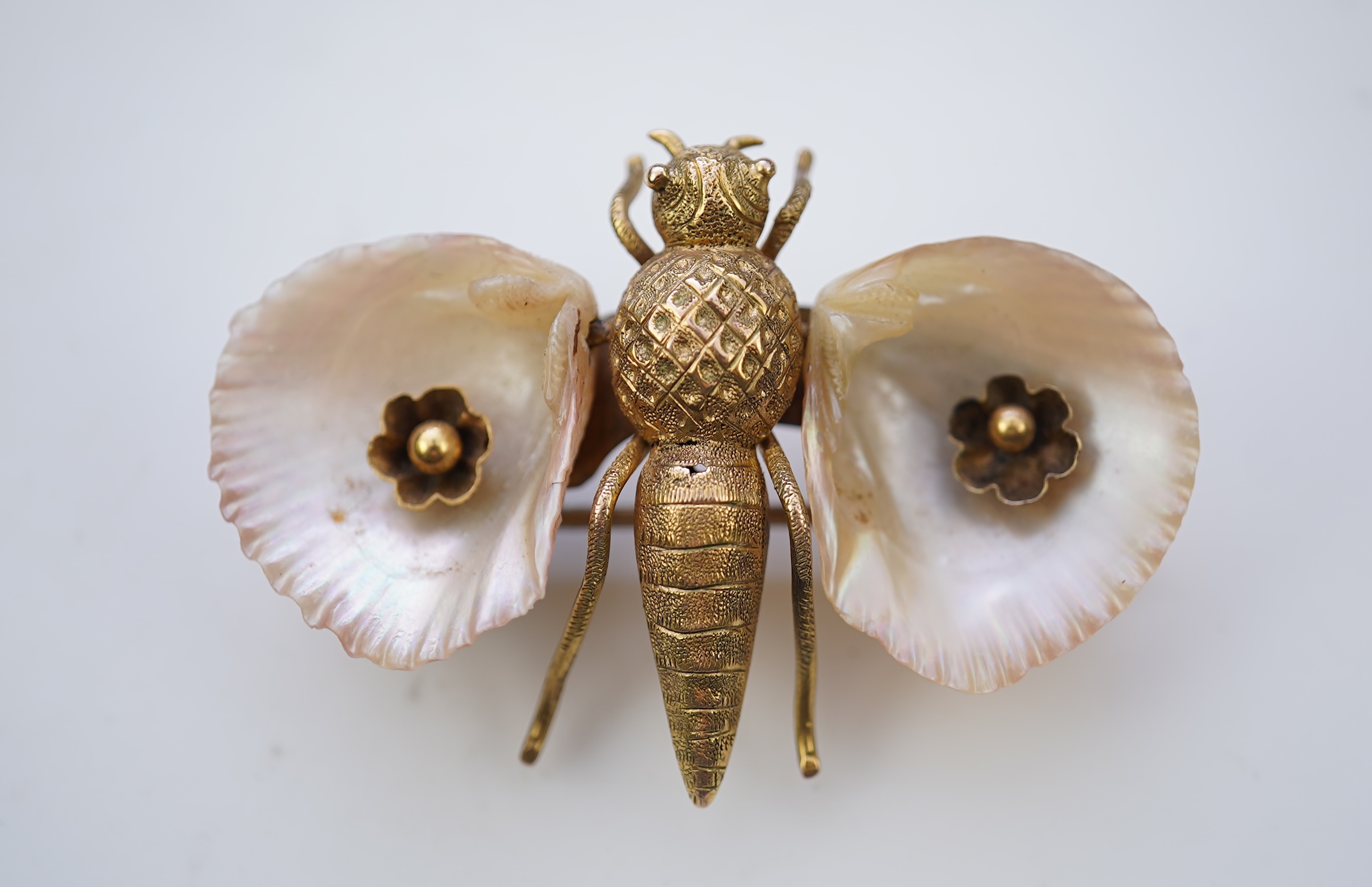 A gold and shell brooch, late 19th century composite